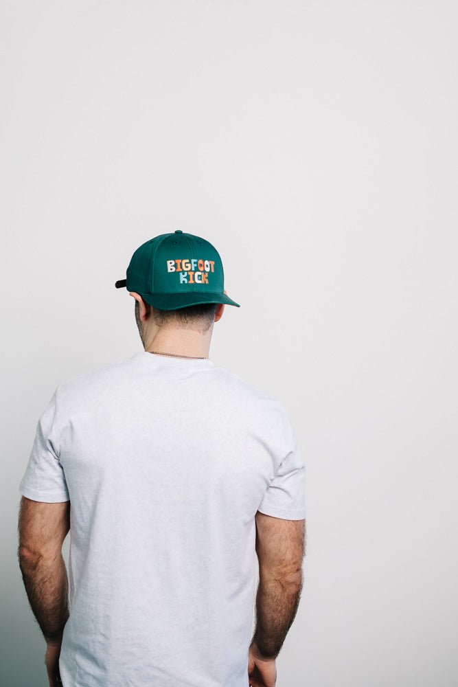 Man wearing a Hidden Bigfoot Hat showing off a fun Bigfoot-themed design.