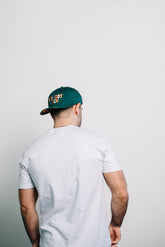 Person wearing a Hidden Bigfoot Hat, showcasing its unique design from the back view.