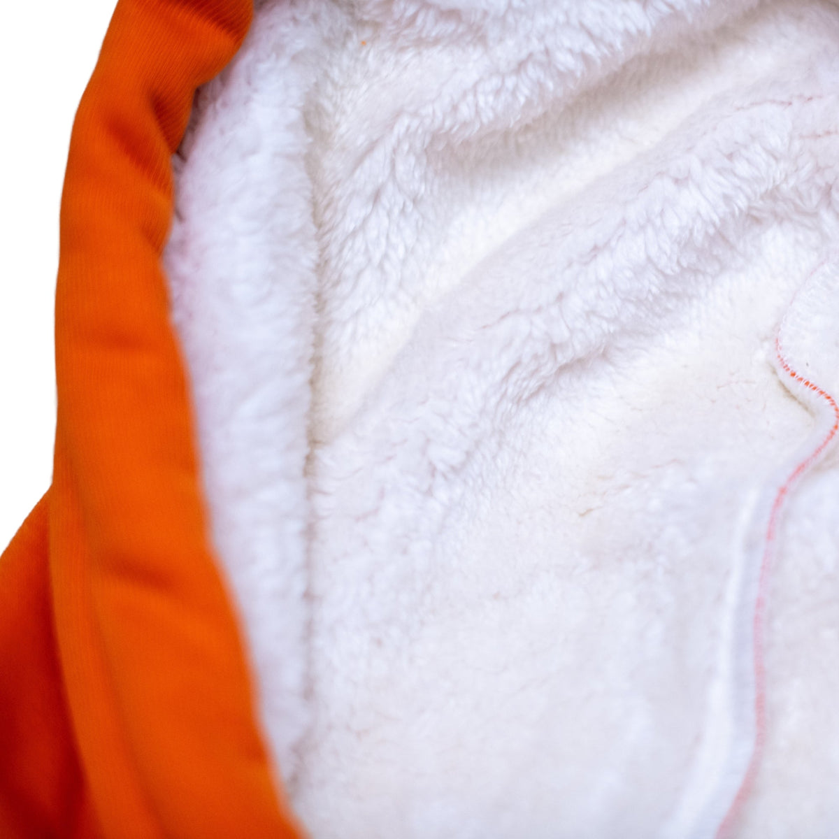 Inside view of the Squatchfuzz Tiger Hoodie showcasing its soft white lining and vibrant orange exterior.