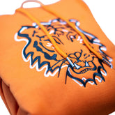 Close-up of the Squatchfuzz Tiger Hoodie featuring a bold tiger design on an orange fabric.